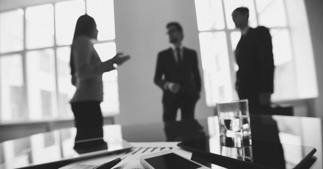 meeting-with-table-in-foreground-grayscale