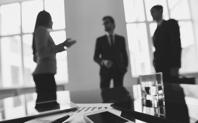 meeting-with-table-in-foreground-grayscale